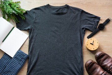 Mockup of a black t-shirt blank shirt template with accessories on the wooden table background,...