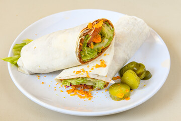 Cig kofte (raw meatball) with lettuce, tomato, pickle and lemon, hot Chee kofta. Turkish local raw food concept.Table scene of assorted take out or delivery foods. Doritoslu cig kofte durum.