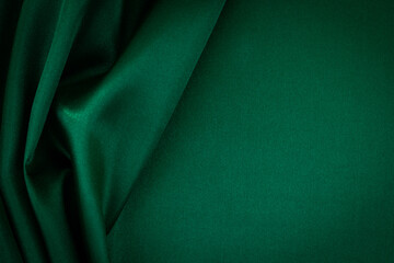 Abstract monochrome elegant luxury cloth background. Green color background with drapery and wavy...