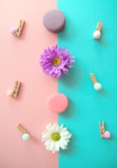 Cakes, macaroons and flowers on a bright background