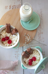 Delicious breakfast with cottage cheese, berries and chocolate and milk. A good start to the day