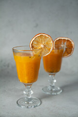 Delicious fruit tea with sea buckthorn and citrus fruits. Medicinal tea in a beautiful glass