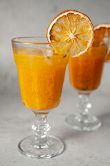 Delicious fruit tea with sea buckthorn and citrus fruits. Medicinal tea in a beautiful glass
