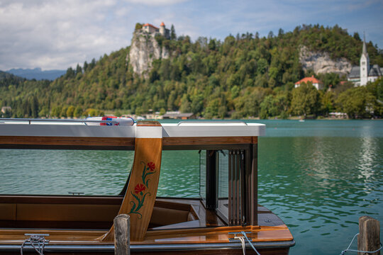 wooden boat near castle and church St. Martina Parish in bled carniola
