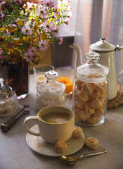 A cup of coffee with little meringue cookies, cozy autumn morning concept.