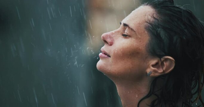 Happy Healthy Caucasian Woman Smiles in the Rain. Close-up Portrait of Attractive Sexy Young Female, Water Drop on face . Adult Girl Enjoying the Rainy Weather. concept of positive thinking, freedom.