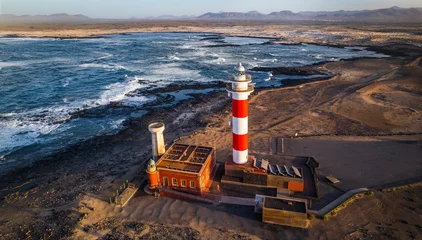 Poster Marine landscape with lighthouse over sunset. aerial drone view, Fuerteventura . Canary island, El Cotilio village. El Toston lighthouse © Freesurf