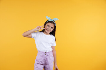 Studio portrait of cheerful  9, 10, 11 years old child girl. Teenager child wearing glasses on yellow background. Cute girl in eyeglasses.