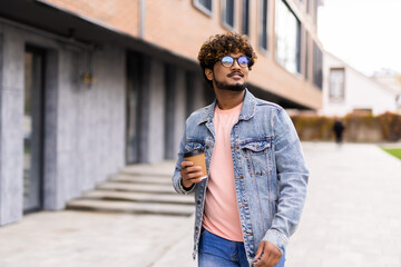 Happy Indian young businessman smiling in the streets outdoors
