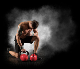 Muscular man workout with red kettlebell