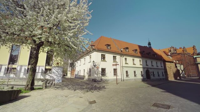 View of the street on Ostrow Tumski in Wroclaw. Old town, historic townhouses, Poland, architecture, Roman Catholic, gothic, neo-gothic, gimbal. 4K Video Footage.