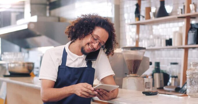 Coffee shop owner, manager or waiter checking tablet for online orders, social media marketing or mobile app for management of inventory. Portrait of barista using technology for business tools 