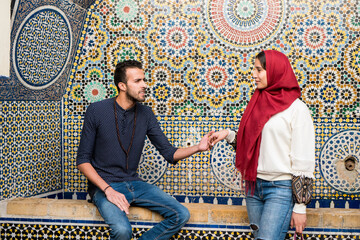 Young Muslim couple in relationship talking and smiling