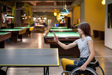 Woman in a wheelchair playing table tennis