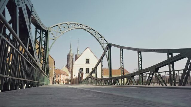 View of the Tumski Bridge and Ostrow Tumski in Wrocław. Old town, Poland, church, architecture, Roman Catholic, gothic, neo-gothic, gimbal. 4K Video Footage.