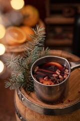 Mulled wine in a copper pot with spices on a wooden table