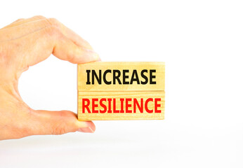 Increase resilience symbol. Concept word Increase resilience typed on wooden blocks. Beautiful white table white background. Businessman hand. Business and increase resilience concept. Copy space.