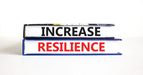 Increase resilience symbol. Concept word Increase resilience typed on books. Beautiful white table white background. Business and increase resilience concept. Copy space.