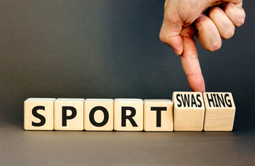 Sport or sportswashing symbol. Concept words Sport and Sportswashing on wooden cubes. Businessman hand. Beautiful grey table grey background. Business sport sportswashing concept. Copy space.