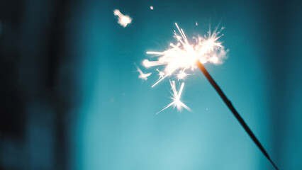 Sparklers on blue background with copy space