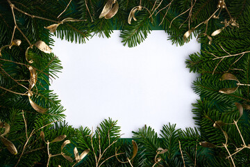 Festive Christmas holiday background with a copy space for text. Flat lay photograph of a decorative frame made from fir branches and mistletoe. - 551854634