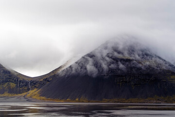 The striking Iceland landscape with clouds and mountains.