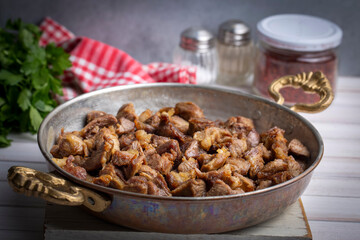 Muslims Traditional Sacrifice holiday food lamb, Turkish roasted meat in copper pot on table top. Turkish Kavurma. (Turkish name; Kurban kavurma)