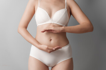 Close-up beauty asian woman in white bra and panties isolated over white background.