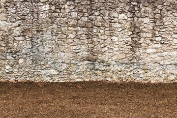 Old stone wall background with autumn grass