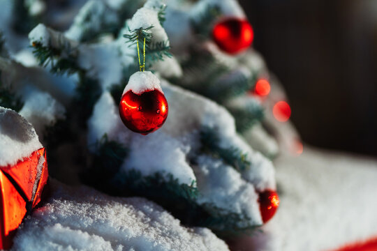 christmas tree with gifts on the roof of a red car. New Year's decoration of a rare car with spruce branches and red boxes. christmas photo zone in a photo studio for a photo shoot.