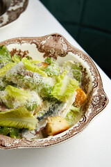 fresh caesar salad with anchovies on a beautiful plate