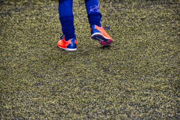 feet on the grass, young football player