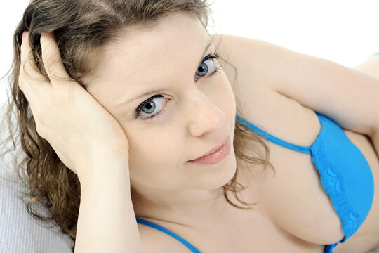 Portrait of a beautiful brunette woman wearing lingerie as underwear in bed