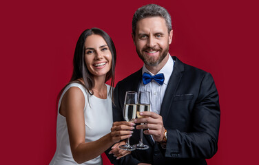 happy couple in tuxedo cheering on formal occasion. studio shot of formal tuxedo couple cheering.