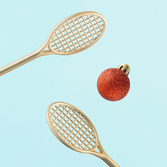 Minimal creative abstract aesthetic sport New Year card concept with gold tennis rackets and red...