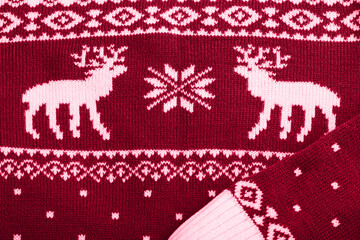 Year 2023 color Viva magenta. Fragment of knitted sweater with a deer pattern