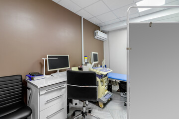 banner with empty medical office with ultrasound machine and blue couch. patient waiting