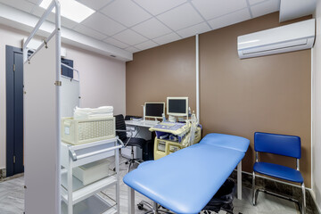 banner with empty medical office with ultrasound machine and blue couch. patient waiting