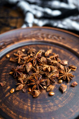 Dried anise on a clay plate vertically close-up
