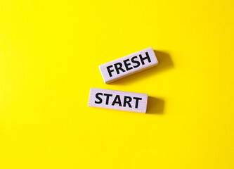 Fresh start symbol. Wooden blocks with words Fresh start. Beautiful yellow background. Business and Fresh start concept. Copy space.