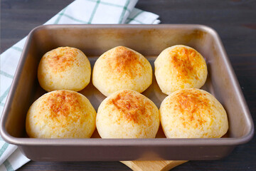 Freshly baked Brazilian cheese breads or Pao de Queijo in a baking tray
