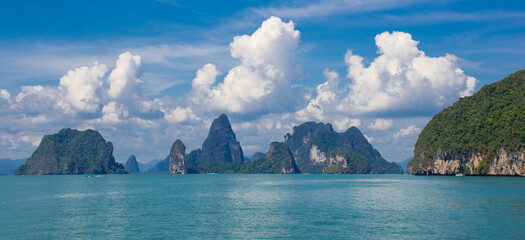 Classic view in the Andaman Sea. Water, mountain and cloudy sky. 