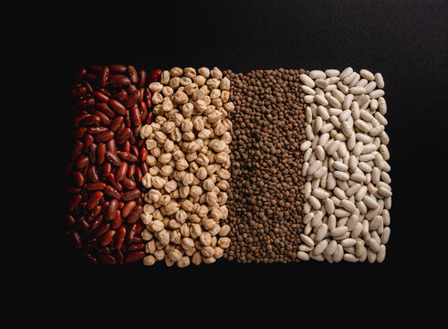 legumes over black background lentils beans haricots chickpeas