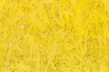 Yellow paint pressed wood texture, chipboard light bright vibrant surface background osb particleboard