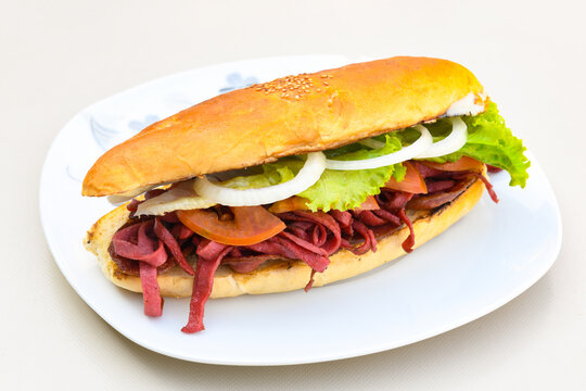 Close-up shot of Izmir's famous Turkish Traditional Kumru Sandwich, Ceşme Kumru, patso ingredients ready to eat salami, soudjouk, tomato, cheddar cheese and fried cheese. Yengen sandvic.