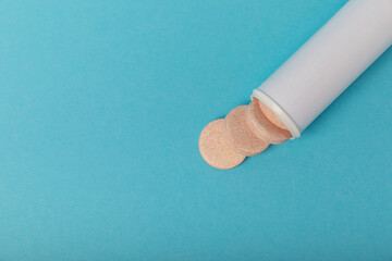 Multivitamin effervescent tablets. Soluble tablets of vitamin C. Calcium vitamin. Effervescent vitamin on a blue background. Medicine concept. Immunity.Place for text.