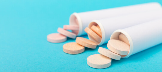 Multivitamin effervescent tablets. Soluble tablets of vitamin C. Calcium vitamin. Effervescent vitamin on a blue background. Medicine concept. Immunity.Place for text.