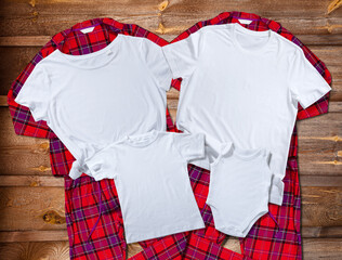 Blank white t-shirts for the whole family on the background of bright pajamas