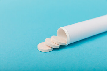 Multivitamin effervescent tablets. Soluble tablets of vitamin C. Calcium vitamin. Effervescent vitamin on a blue background. Medicine concept. Immunity.Place for text.