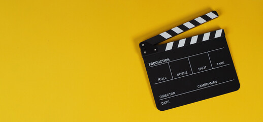 Fototapeta na wymiar clapper board or movie slate on yellow background.
